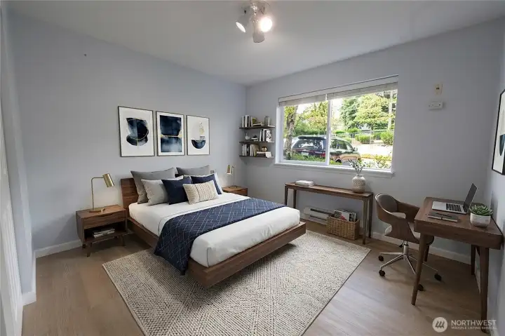 Versatile secondary bedroom with luxury vinyl plank flooring, abundant natural light and flexible space for guests, a home office or hobbies