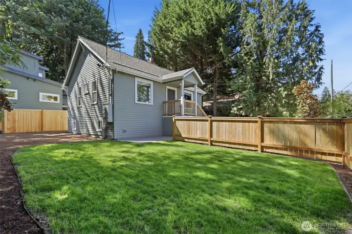 Fully fenced yard on the side of the house with newly planted sod. Fully fenced yard on the side of the house with newly planted sod.