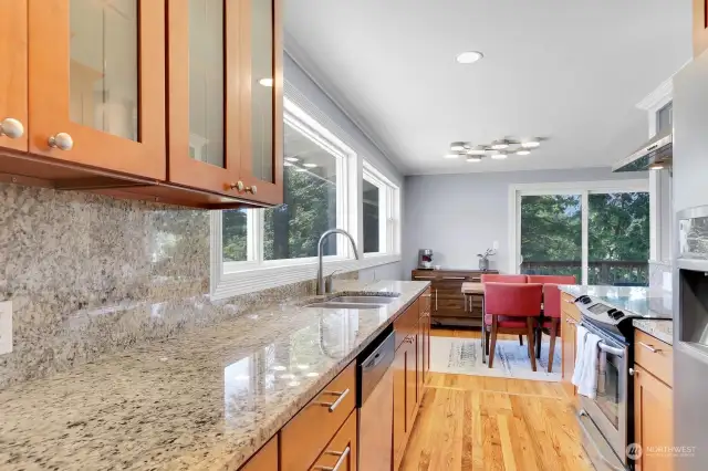 Sleek and functional kitchen.  Granite countertops and backsplash, abundant cabinet and counter space.