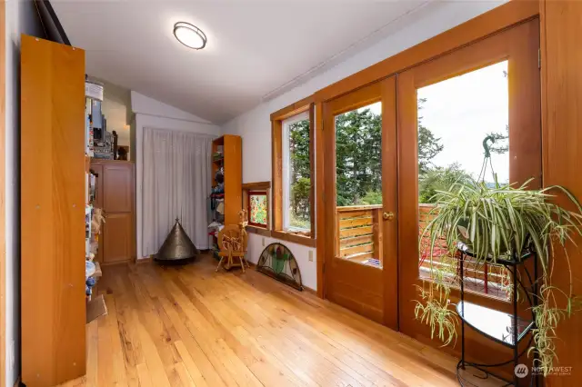 Side room with lots of light and wood floors.