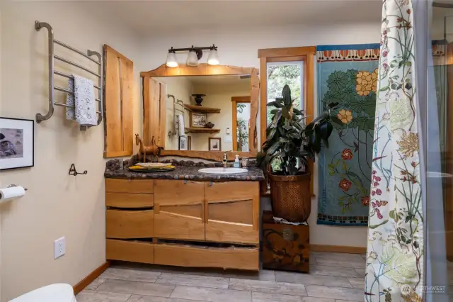 Bathroom has custom wood cabinets and wood work.