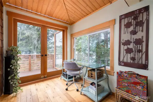 Office off of living area with glass doors to deck.