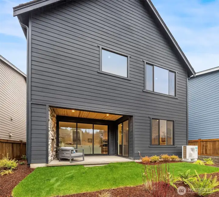 Outdoor luxury living features sliding stacking doors from the great room & cozy gas fireplace.