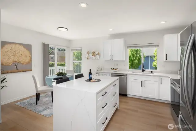 Quartz Dual Waterfall Island w/Bar Seating and Soft Close Drawers Throughout Kitchen, Eating Space & Slider to Deck