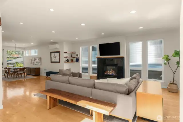 Living room showcases hardwood floors & a gas fireplace