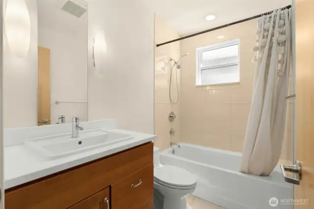 Full bathroom on the upper level services second bedroom