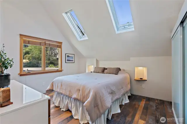Apartment bedroom with skylights.