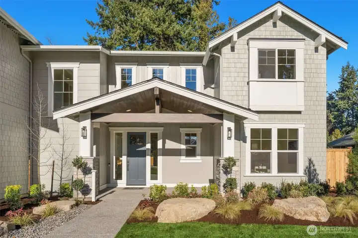 Gorgeously Landscaped with a covered entry and Oversized Front Door- This home is Sure to Impress