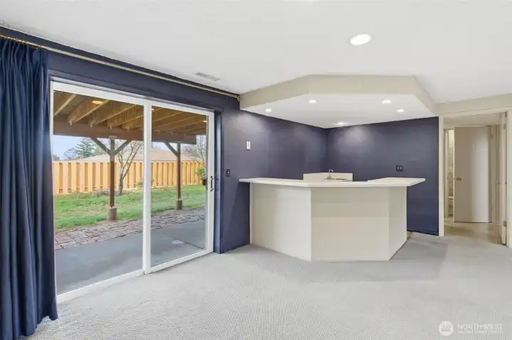 Lower level offers bar area and huge recreation room and it leads to patio and backyard