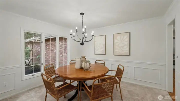Formal dining space with large windows, new carpet, and updated lighting is a wonderful setting for formal gatherings or weeknight dinners.