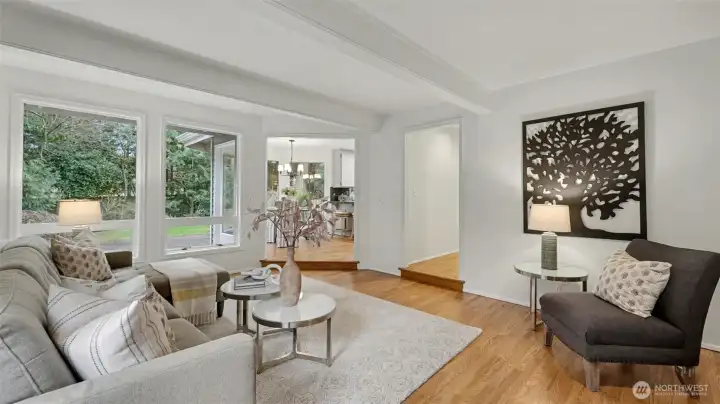 Expansive windows highlight the refinished wood floors and painted wood beams.