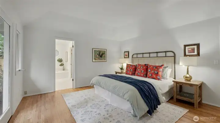Generous main-level primary suite with a coffered ceiling.