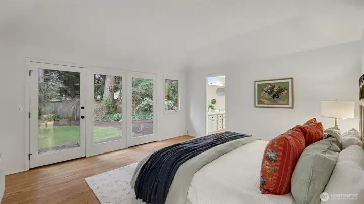 Main-level suite with a French Door and ideal hardwood flooring leading to private backyard patio.