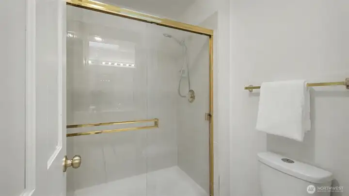 Large glass framed shower in the primary bath.