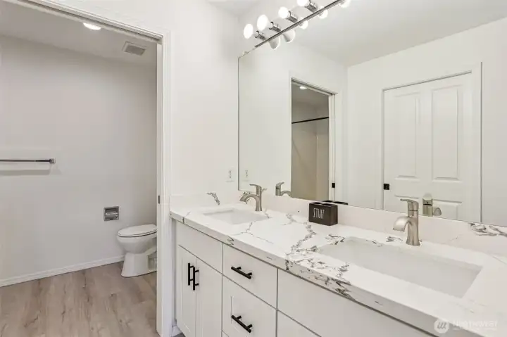 The primary ensuite with double vanity and walk-in closet.