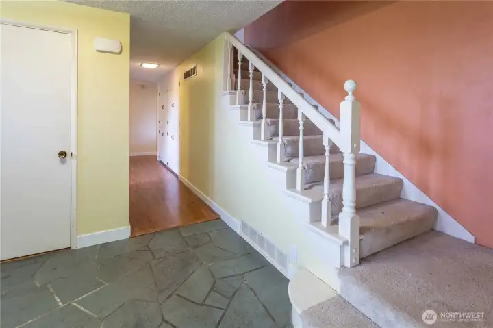 entry closet and stairs to 2nd floor, notice the built in storage in hall