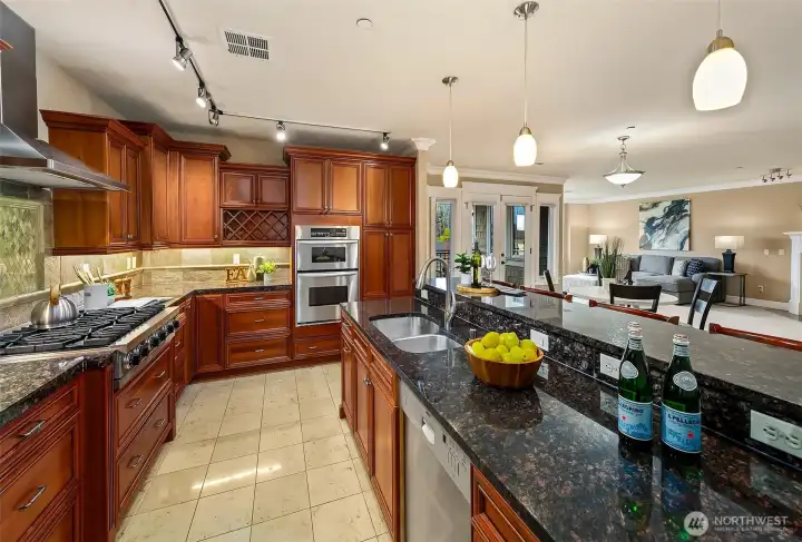 Gorgeous kitchen features chef-grade appliances, including Viking and Sub-Zero , granite slab and tile backsplash.