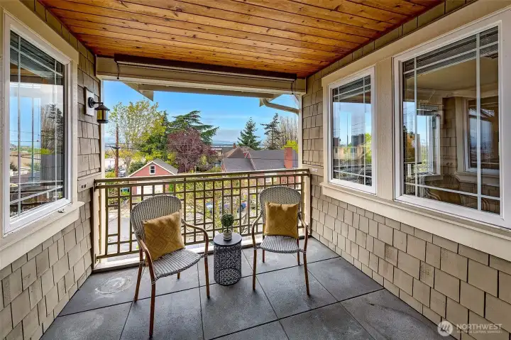 Walls of windows & private covered deck make the most of Sound & Olympic views.