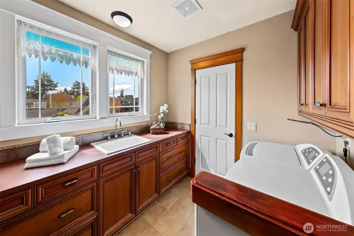 Full-size utility room with tons of storage and a sink.