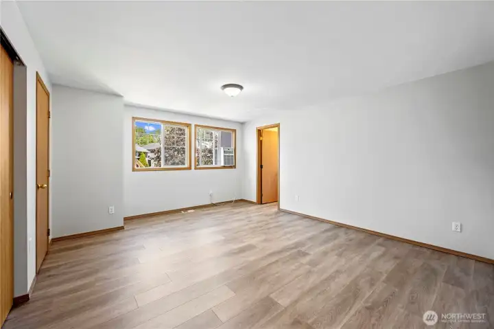 Spacious primary suite featuring updated flooring.