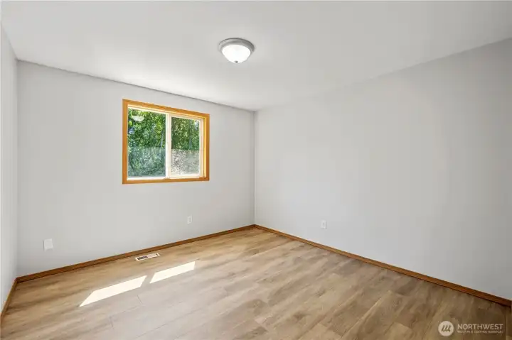 Bright secondary bedroom with natural light.