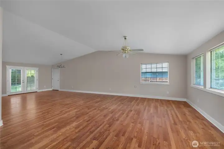Relax, dine, and entertain in the open-concept living space with vaulted ceiling and backyard views. Relax, dine, and entertain in the open-concept living space with vaulted ceiling and backyard views.
