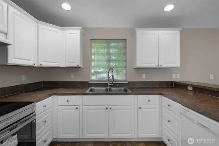 Prepare meals in a bright kitchen with abundant cabinetry, counter space, and natural light. Prepare meals in a bright kitchen with abundant cabinetry, counter space, and natural light.