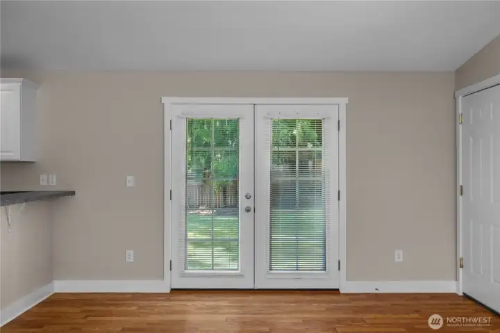 French doors bring natural light into the dining area and open to the private backyard. French doors bring natural light into the dining area and open to the private backyard.