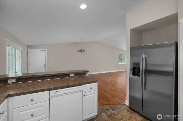 Entertain from the kitchen with a breakfast bar, new refrigerator and new R/O, and an open view to the living space. Entertain from the kitchen with a breakfast bar, new refrigerator and new R/O, and an open view to the living space.