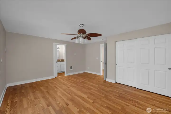 Unwind in the primary bedroom with fresh paint, updated floors, closet storage, and an attached bath nearby. Unwind in the primary bedroom with fresh paint, updated floors, closet storage, and an attached bath nearby.