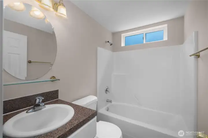 Hall Bath - Full bathroom with tub/shower surround, vanity, tile-look counter, and new toilet. Hall Bath - Full bathroom with tub/shower surround, vanity, tile-look counter, and new toilet.