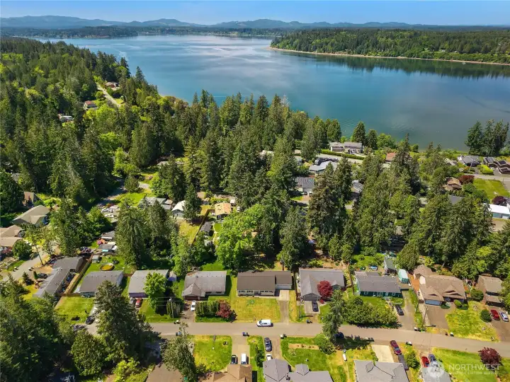 Aerial view captures Carlyon Beach neighborhood, Puget Sound shoreline, and nearby community waterfront access. Aerial view captures Carlyon Beach neighborhood, Puget Sound shoreline, and nearby community waterfront access.