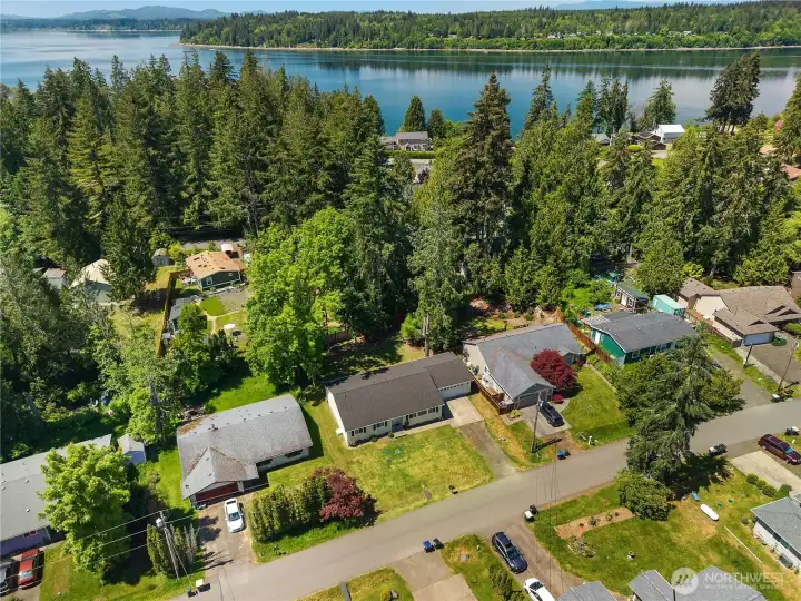 Aerial view shows the home near Carlyon Beach waterfront, community marina, and Puget Sound shoreline. Aerial view shows the home near Carlyon Beach waterfront, community marina, and Puget Sound shoreline.