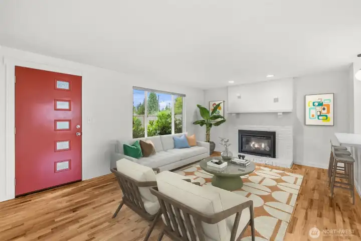 Sunny living room with hardwood floors, gas fireplace and power blinds. This photo virtually staged. Sunny living room with hardwood floors, gas fireplace and power blinds. This photo virtually staged.