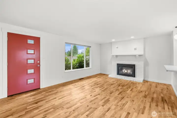Sunny living room with hardwood floors, gas fireplace and power blinds. Sunny living room with hardwood floors, gas fireplace and power blinds.