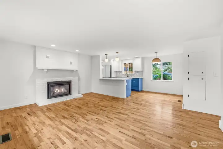 Sunny living room with hardwood floors, gas fireplace and power blinds. Sunny living room with hardwood floors, gas fireplace and power blinds.