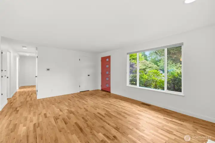 Sunny living room with hardwood floors, gas fireplace and power blinds. Sunny living room with hardwood floors, gas fireplace and power blinds.