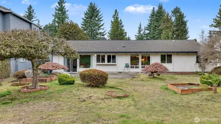 This generous backyard offers garden space, mature landscaping, and endless potential.