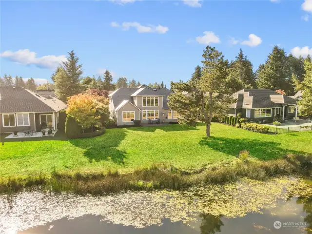 REAR VIEW - House in the middle - Wow...!!! Overlooks the pond and fairway!!!