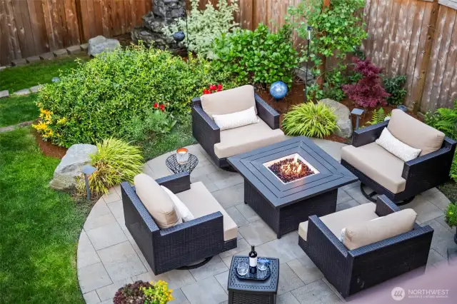 Fire pit pad grace the back yard along with a water feature and out building to store the yard toys.