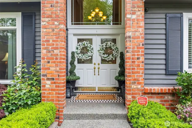 The double door entry is majestic and covered.