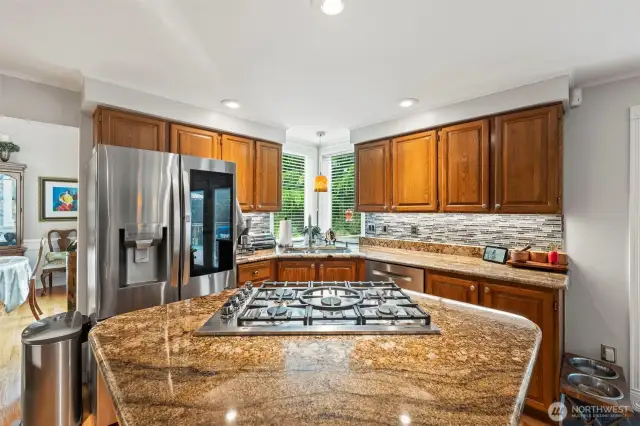 The island 5 burner cook top is a chefs dream with pop up down draft. All appliances are 5 years or newer with exception to the microwave.