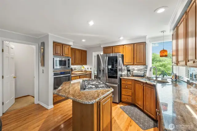 Granite  counters, tile back splash pop against the stainless steel appliances.