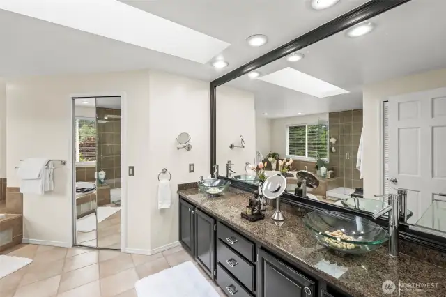 The primary en-suite is tranquil and spa like.