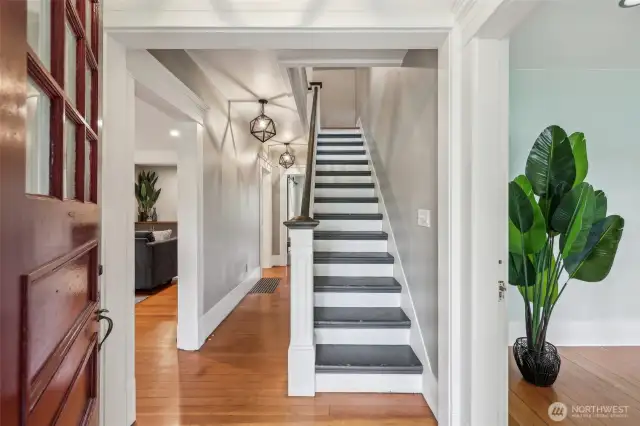 Welcoming entry off covered porch – original hardwoods + thoughtful updates