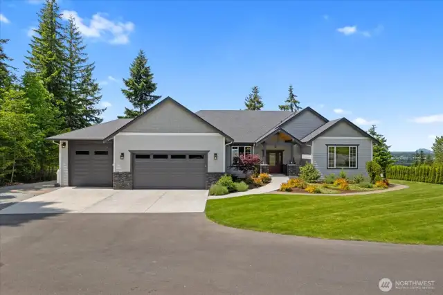 Home has been professionally landscaped.  Large driveway provides ample parking.  3 car garage features an RV Bay with electric car charger, epoxy floors, heated and air conditioned garage.  Plenty of room for indoor projects!