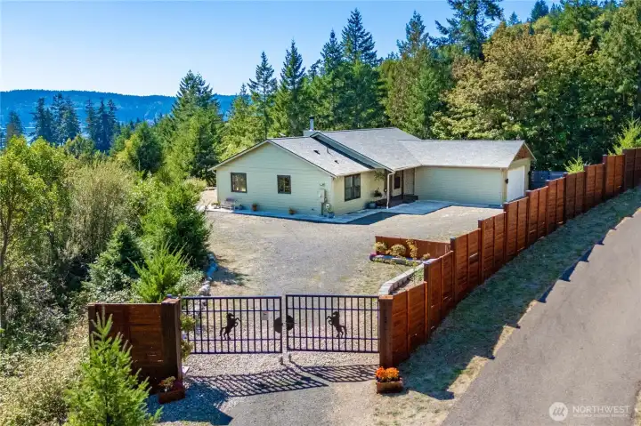 Secure gated access leads to a private retreat, embraced by the beauty of nature.