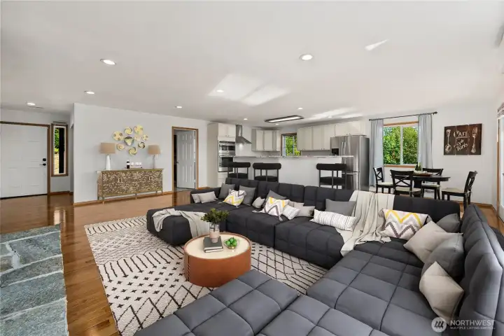 Bright and open living room seamlessly flows into the kitchen, perfect for entertaining.