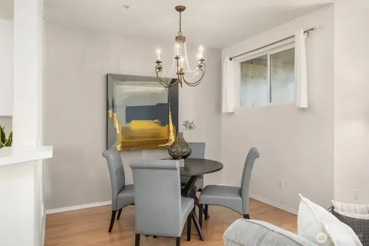 The dining room boasts a stunning chandelier that adds a touch of elegance to the space.