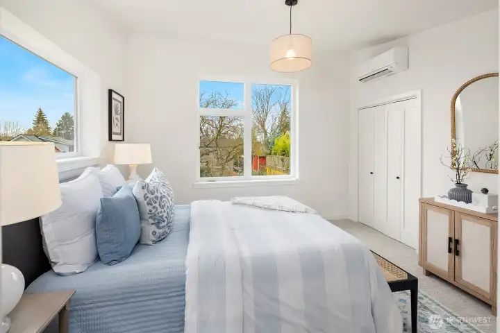 Teh primary bedoom.  Looking south through the oversized windows and a view of the small closet.